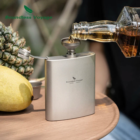 pouring-whiskey-from-titanium-flask-at-campsite