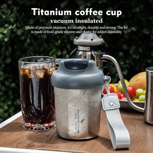 holding-titanium-vacuum-mug-with-coffee-outdoors