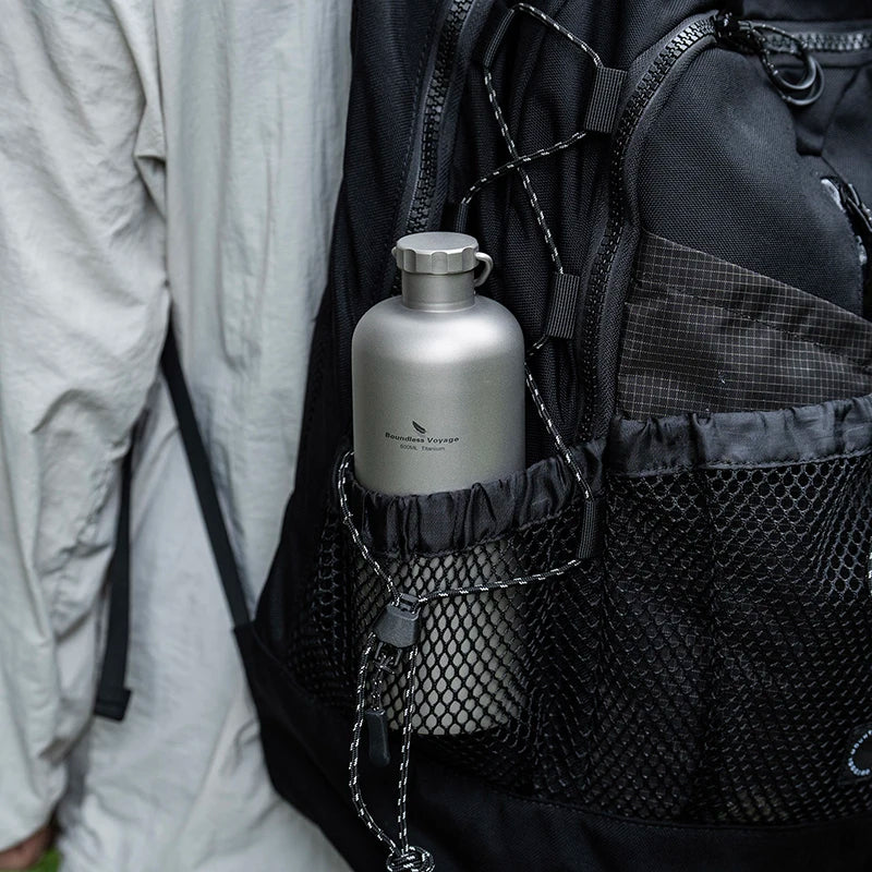 carrying-titanium-water-bottle-on-hiking-trail