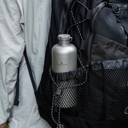 carrying-titanium-water-bottle-on-hiking-trail