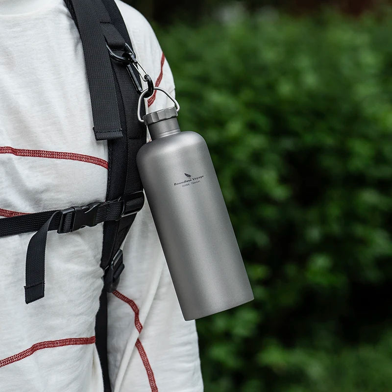 carrying-titanium-water-bottle-on-hiking-trail