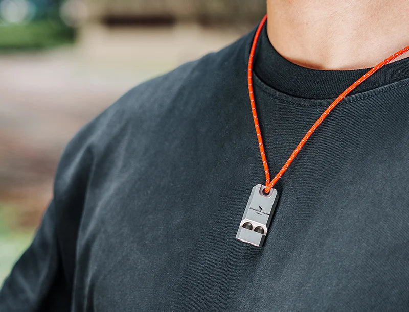 blowing-titanium-whistle-for-emergency-signal