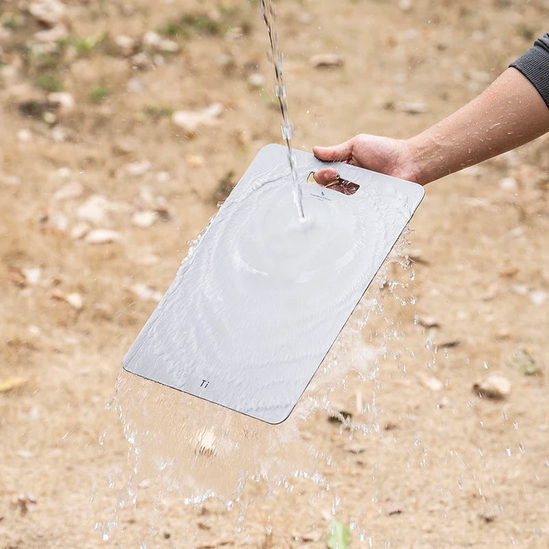 using-titanium-cutting-board-at-campsite-for-food-prep