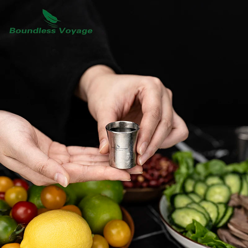 pouring-whiskey-into-titanium-shot-glass-at-home-bar