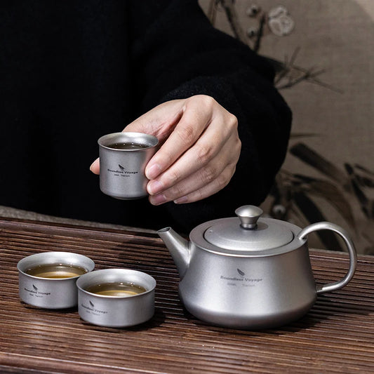 pouring-tea-from-titanium-teapot-at-campsite