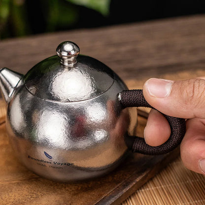 pouring-tea-from-titanium-teacup-set-at-home