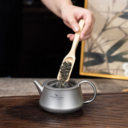 pouring-tea-from-titanium-teapot-at-campsite