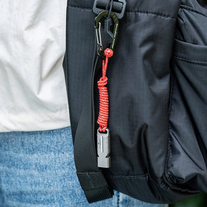 titanium-whistle-attached-to-backpack-for-hiking-safety