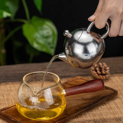 pouring-tea-from-titanium-teacup-set-at-home