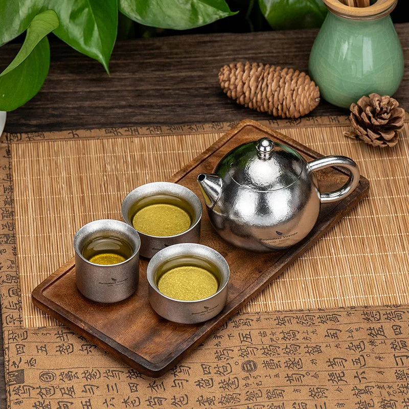 pouring-tea-from-titanium-teacup-set-at-home