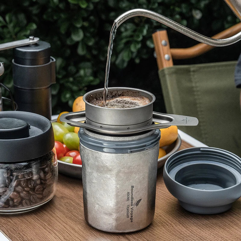 holding-titanium-vacuum-mug-with-coffee-outdoors